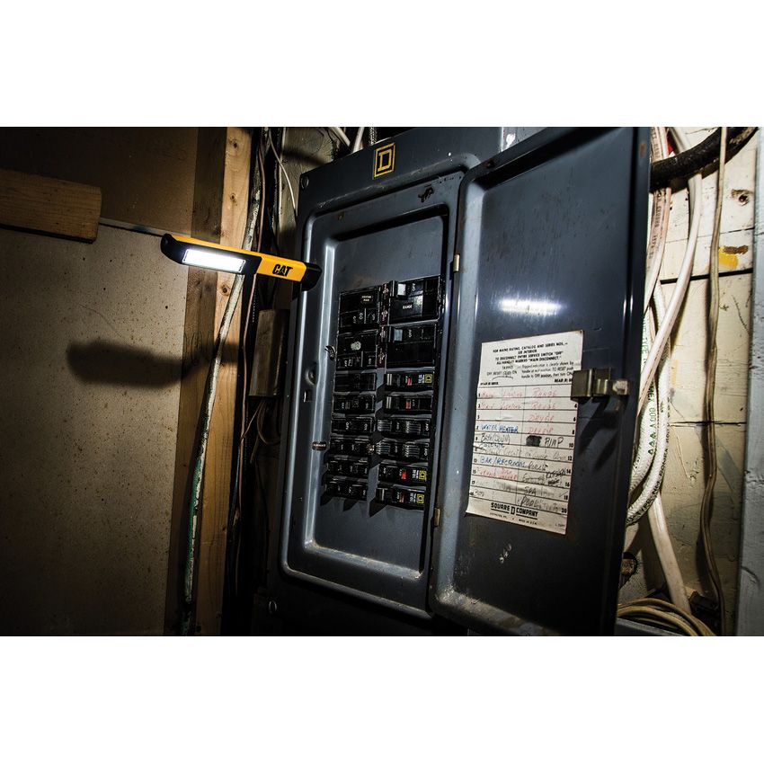 CAT Pocket Worklight magnetically mounted while working on an electrical panel